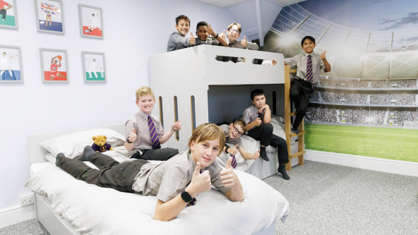 Boarders on the beds in a dorm at Aldwickbury School