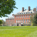 Bryanston School, Dorset: A scenic view of Bryanston School in Dorset, surrounded by greenery.