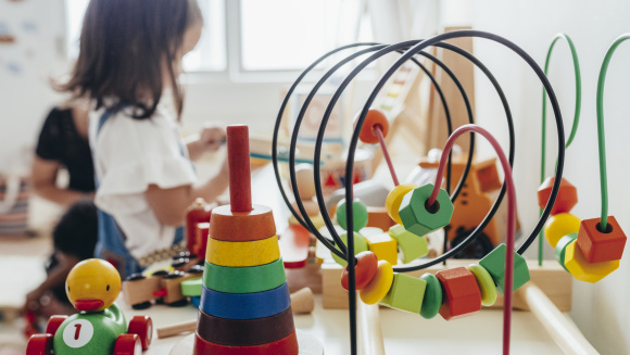 Young girl playing with educational toys at prep school
