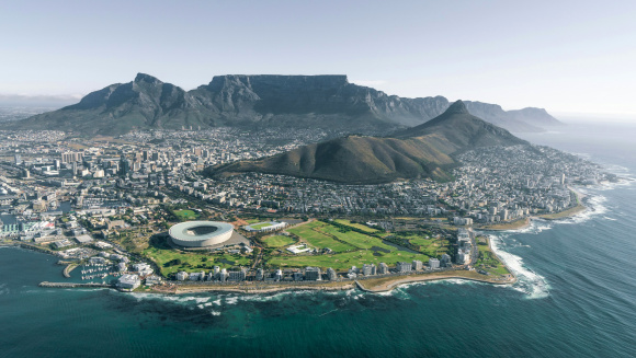 Aerial view of Cape Town with sports stadium in the foreground and table mountain in the background