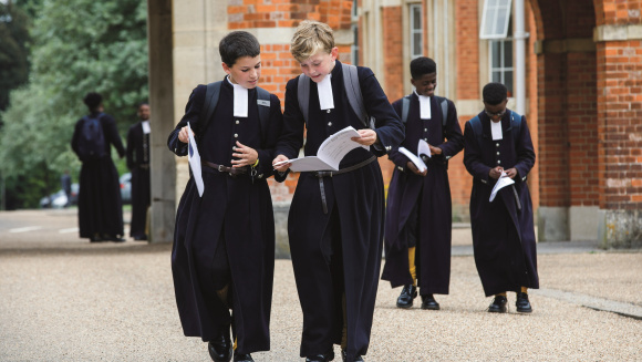 Pupils of Christ's Hospital School walking through the school in their famous uniform