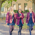 Three pupils from Didcot Girls' walking in the school grounds