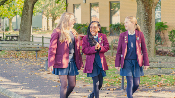 Three pupils from Didcot Girls' walking in the school grounds
