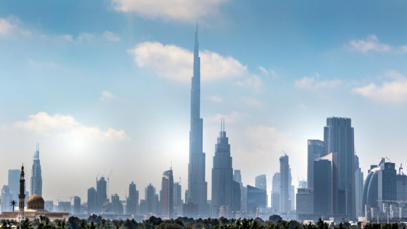 Dubai skyline on a blue sky with the Burj Khalifa central