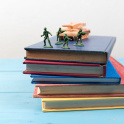 Some children's toys on a pile of books