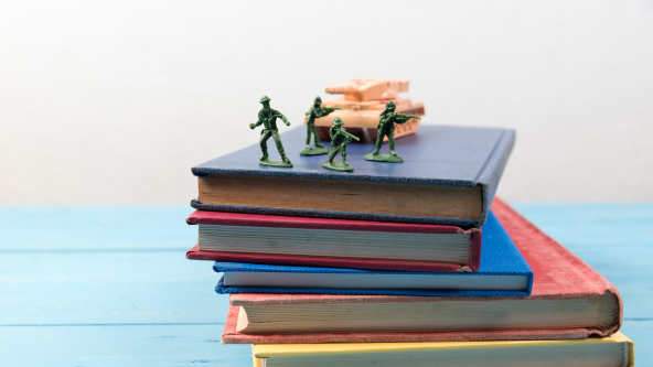 Some children's toys on a pile of books