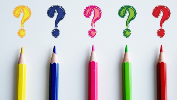 Coloured pencils drawing question marks