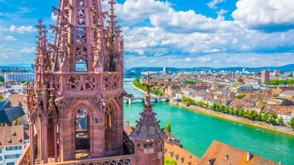 Riverside of Rhine in Basel dominated by majestic building of Munster church, Switzerland
