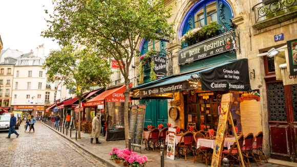 Latin Quarter. Narrow street of Paris among old traditional Parisian houses and cafe in Paris, France
