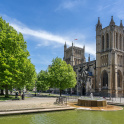 Bristol Cathedral on College Green in Bristol with blue sky.