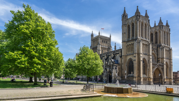 Bristol Cathedral on College Green in Bristol with blue sky.