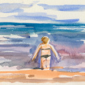 A woman wading into the sea