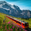 Electric passenger train and snowy Jungfrau mountains in background, Switzerland