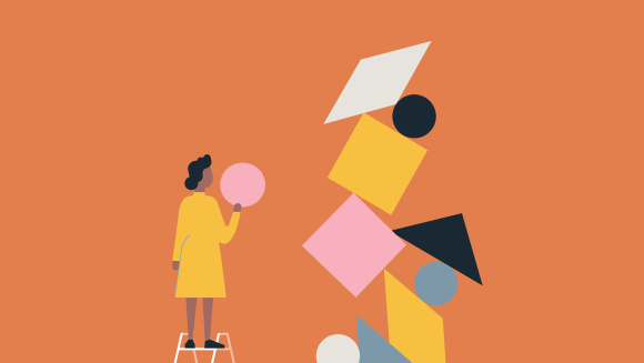 A woman balancing objects to create structure