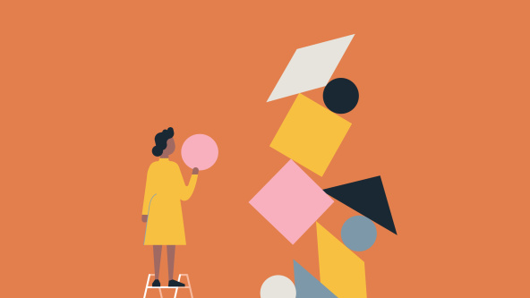 A woman balancing objects to create structure