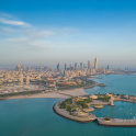 High-angle shot of The Green Island with a skyline of the city of Kuwait in the background