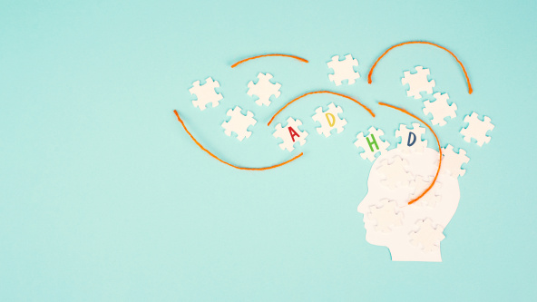 A head made from jigsaw pieces with the letters ADHD