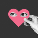 A hand holding a heart with eyes on it