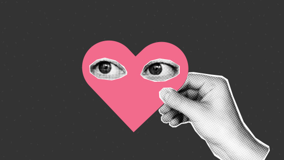 A hand holding a heart with eyes on it