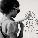 An illustration of a girl drawing flowers that turn into roses