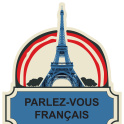 A badge with the Eiffel Tower that reads 'parlez-vous Francais'