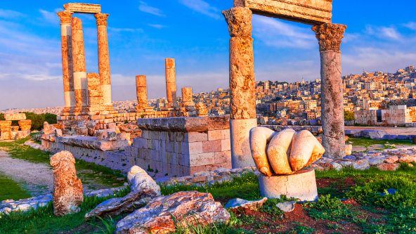 Amman Jordan: The fallen hand and the temple of Hercules on the Amman citadel in sunset lights