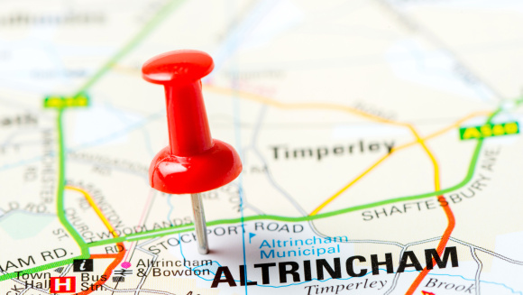A red pin pushed into a road map at Altrincham