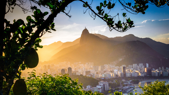 Buildings at the waterfront with Christ The Redeemer statue in the background, Corcovado, Rio de Janeiro, Brazil