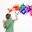 A child painting something colourful on a white wall