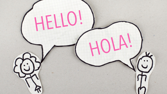 Two cut out illustrations of children saying hello and hola