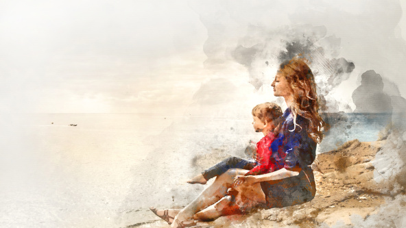 A parent and child looking at the sea