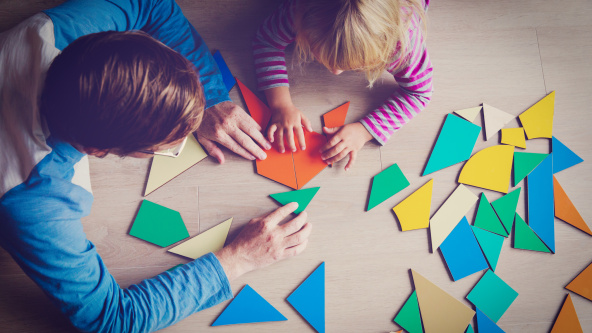 A teacher and child playing with shapes