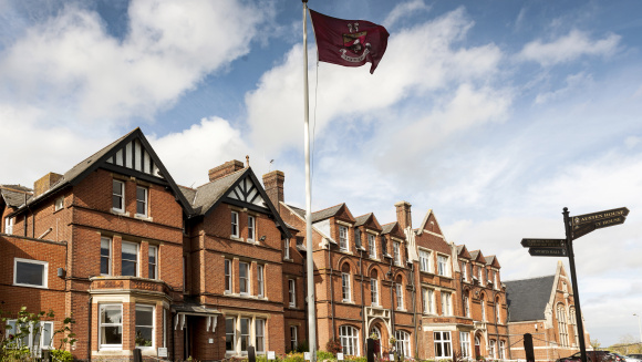 The facade of Kent College, Canterbury, with the school's flag flying high on the flagpole