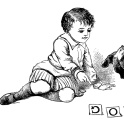 A small boy teaching a dog how to read the word DOG