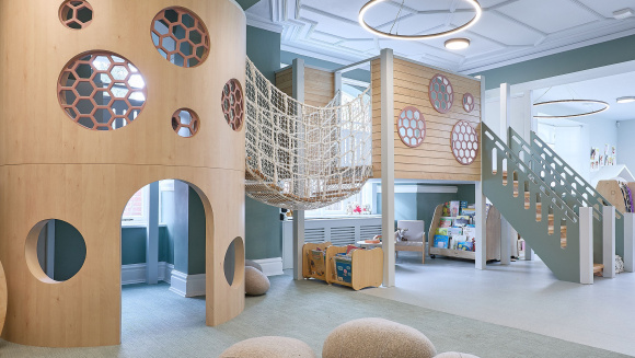 Orchard House School nursery room with climbing apparatus, bookshelves and cushions