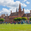 Football practice takes place in front of Reading Schools striking red-brick building
