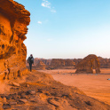 Man hiking in a desert in Al Ula, Saudi Arabia.