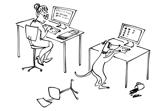 A woman and a dog both working at their desks