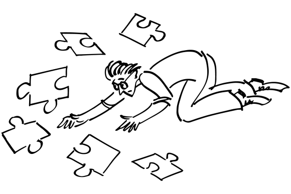 A parent on the floor trying to fit jigsaw pieces together