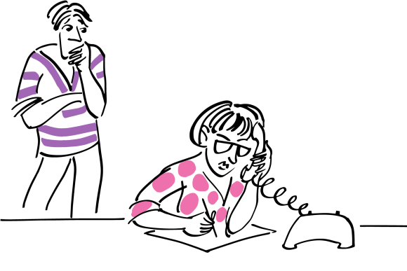 Two parents, with one on the phone to a consultant