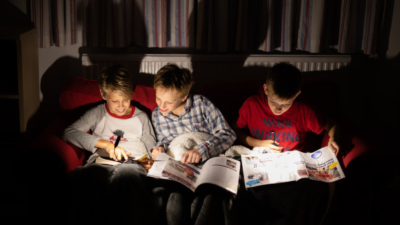 Boarding pupils at St Hugh's, Faringdon, reading at night under torch light