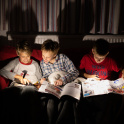 Boarding pupils at St Hugh's, Faringdon, reading at night under torch light