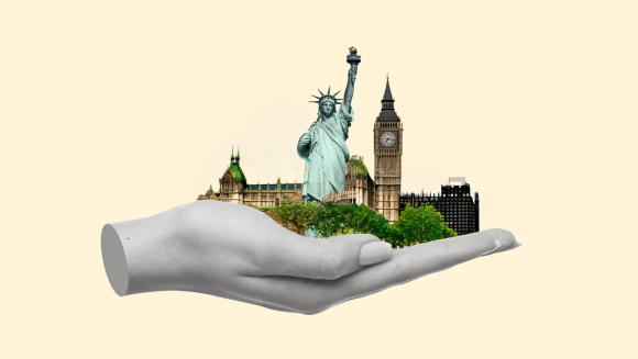 A hand holding the Statue of Liberty and Big Ben