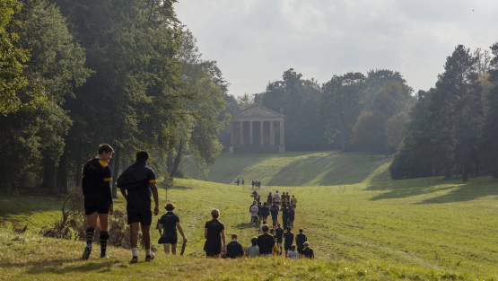 Stowe pupils in sports kit return to school past palladian architechture