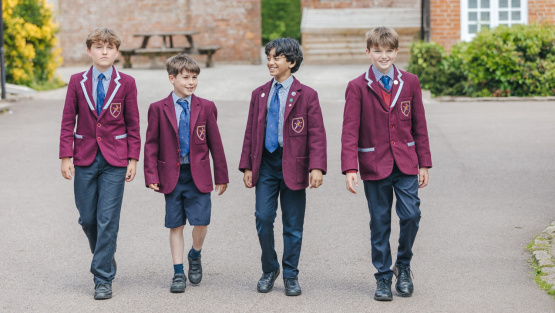 For pupils in school uniform walking across the school yard
