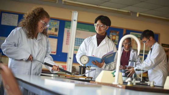 Edgbarrow pupils wearing white coats in the science lab