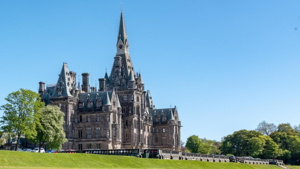 The impressive, ornate neo-gothic main building of Fettes College, against a blue sky