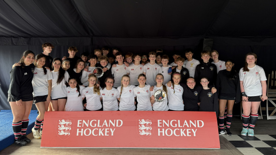 Squad photo showing success boys' and girls' teams holding their trophies