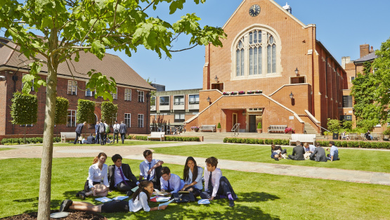 Pupils relax on the grass at King's College School, Wimbledon