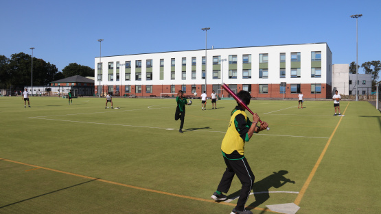 Langley Grammar pupils play baseball on the school's astroturf pitch